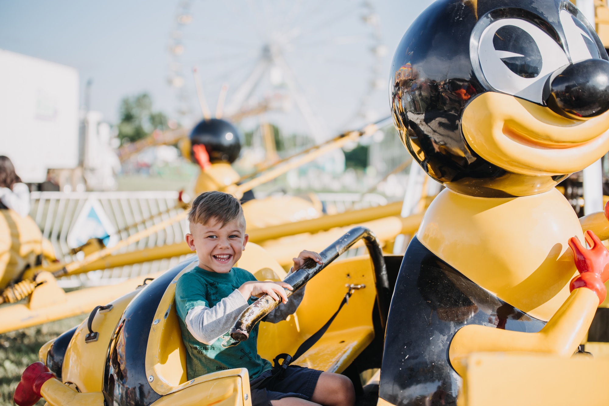 A child smiling on an amusement park ride